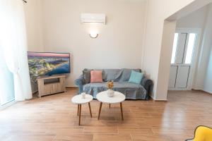 a living room with a couch and two tables at Skyard - Central 2bd House in Kos