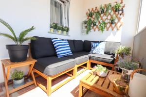 a living room with a couch and potted plants at Relax Mandre 200m from the beach Sea view in Mandre