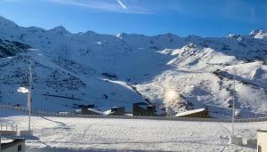 a snow covered mountain with a ski slope at Val Thorens Appartement Cosy centre station in Val Thorens