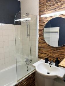 a bathroom with a sink and a shower and a mirror at Val Thorens Appartement Cosy centre station in Val Thorens +7 photos