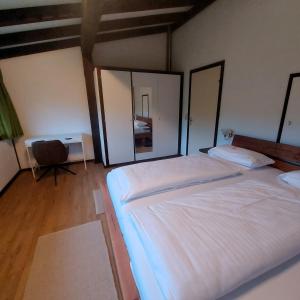 a bedroom with two beds and a mirror at Haus Seidelbast in Siegsdorf +16 photos
