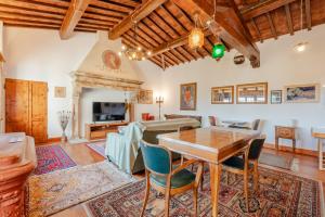 a living room with a table and chairs at I Palpiti - Dream Villa in Florence in Florence
