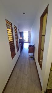 a hallway with a table and a desk in a room at Le Ballah in Noumea