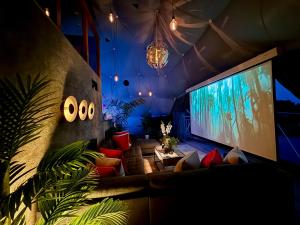 a living room with a large screen and a couch at Sunridge Geodome with private Hot tub in Plymouth