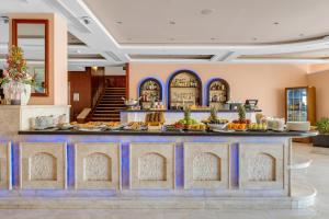 a buffet in a hotel lobby with food at Royal Savoy Sharm El Sheikh in Sharm El Sheikh
