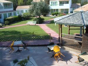 a patio with chairs and a gazebo at Le Parasol in Ars-en-Ré