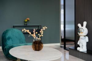 a room with a table and a vase with flowers at 云深处江景公寓 in Chongqing