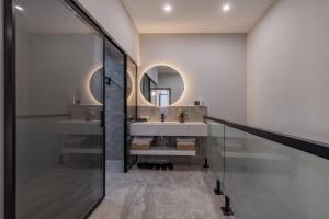 a bathroom with a sink and a mirror at 云深处江景公寓 in Chongqing