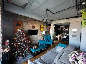 a living room with a christmas tree in it at Penthouse studio Lola New Belgrade in Novi Beograd