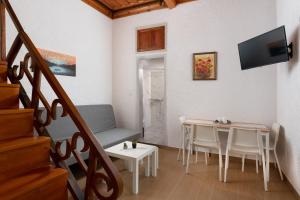 a living room with a table and chairs and a tv at Casa Tradizionale in Rhodes Town