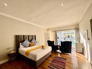 a bedroom with a bed and a large window at Vinorisa Spa & Lodge in Pretoria +41 photos