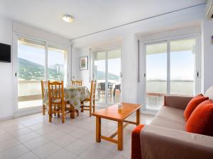 a living room with a couch and a table at LLANÇÀ 11 ÀTIC - Ático en primera línea de mar, gran terraza y piscina comunitaria - ES-228-60 in Port de la Selva