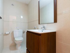 a bathroom with a toilet and a sink and a mirror at LLANÇÀ 11 ÀTIC - Ático en primera línea de mar, gran terraza y piscina comunitaria - ES-228-60 in Port de la Selva +20 photos