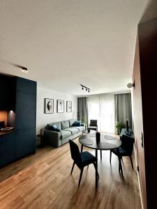 a living room with a table and chairs and a couch at PURA Vida in Gdynia