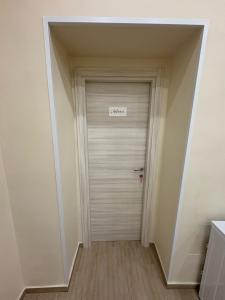 a hallway with a white door with a sign on it at Vikolo Apartments in Naples +19 photos