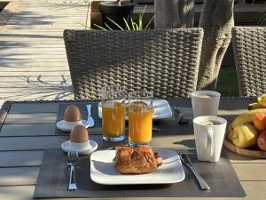 a table with a plate of food and eggs and drinks at Le Gite Hector in Carcassonne