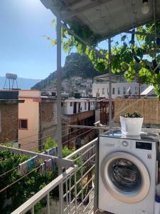 a washing machine on a balcony with a view at Flat in Berat's Center & Great Terrace in Berat