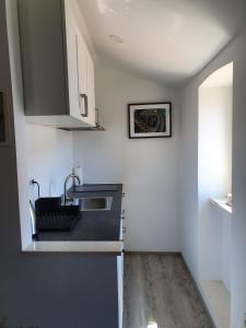 a kitchen with a sink and a counter top at Slatki kut in Vis