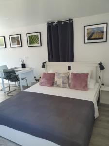 a bedroom with a large bed with pillows and a table at Slatki kut in Vis