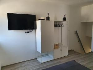 a white cabinet with a television on top of it at Slatki kut in Vis