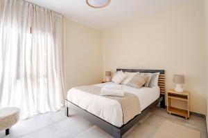 a bedroom with a bed and a large window at Chalet de lujo en Cala Lanuza con vistas al mar in El Campello