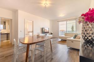 a kitchen and living room with a table and chairs at Bella View By Links in Porto Santo