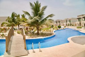 an image of a swimming pool at a resort at Lux Villa Azure 36A in Salalah