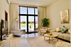 a living room with a couch and a table at Lux Villa Azure 36A in Salalah