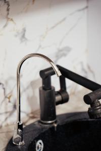 a close up of a kitchen sink with aaucet at Хостел 1377 in Astana