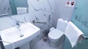 a bathroom with a sink and a toilet at Badyan Boutique Hotel in Bukhara in Bukhara