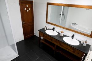 a bathroom with two sinks and a large mirror at Au Lit D'Ô in Bressuire +17 photos