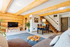 a living room with a couch and a table at Log Garden Estate in Dobrova