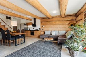 a living room with a couch and a table at Log Garden Estate in Dobrova