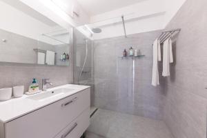 a white bathroom with a sink and a shower at Palais D'orient in Nice +56 photos