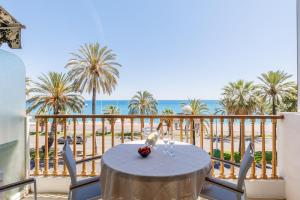 a table on a balcony with a view of the ocean at Palais D'orient in Nice