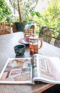 a magazine on a table with a cup and a coffee mug at Boheme House with Bathtub & Terrace in Istanbul +20 photos