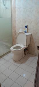 a bathroom with a white toilet and a shower at pradeepa villa in Colombo