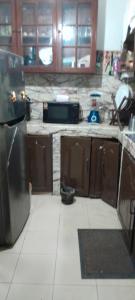 a kitchen with wooden cabinets and a counter top at pradeepa villa in Colombo