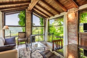 a living room with large windows and a couch at Fattoria di Pietrabuona in Medicina
