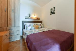 a small bedroom with a bed and a dresser at Villa Lilly 2 in Cesarica