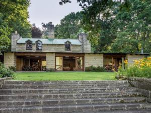 a stone house with stairs leading up to it at Glentowy Farm Underberg in Underberg