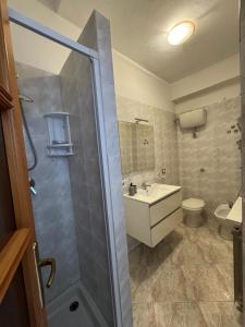 a bathroom with a shower and a sink and a toilet at Camera Giessealghero in Alghero