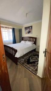 a bedroom with a large bed in a room at Lowell Stays in Nairobi