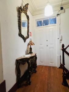 a room with a table and a mirror on the wall at Casa Amore in Montemor-o-Velho +9 photos