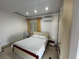 a bedroom with a white bed and a window at Apartment room Noar in Përmet
