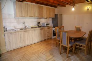 a kitchen with a table and a table and chairs at Careva Cuprija Apartment&Rooms in Sarajevo