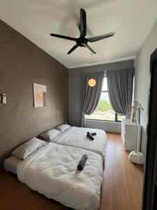 a bedroom with two beds and a ceiling fan at Ipoh Cozy Condo Stadium Greentown 3Br 2bath, 8pax in Ipoh