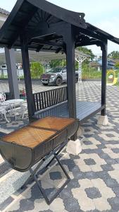 a bench sitting under a pavilion in a parking lot at DZ Tiny Home Kota Bharu With Pool, Wifi in Kota Bharu +9 photos