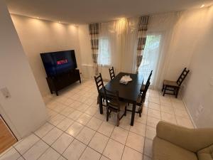 a dining room with a table and a television at Unterkunft 20 Feld Str in Schwabach +11 photos