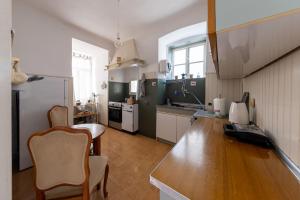 a kitchen with a table and chairs in a room at Casa Tradizionale Volosko in Opatija